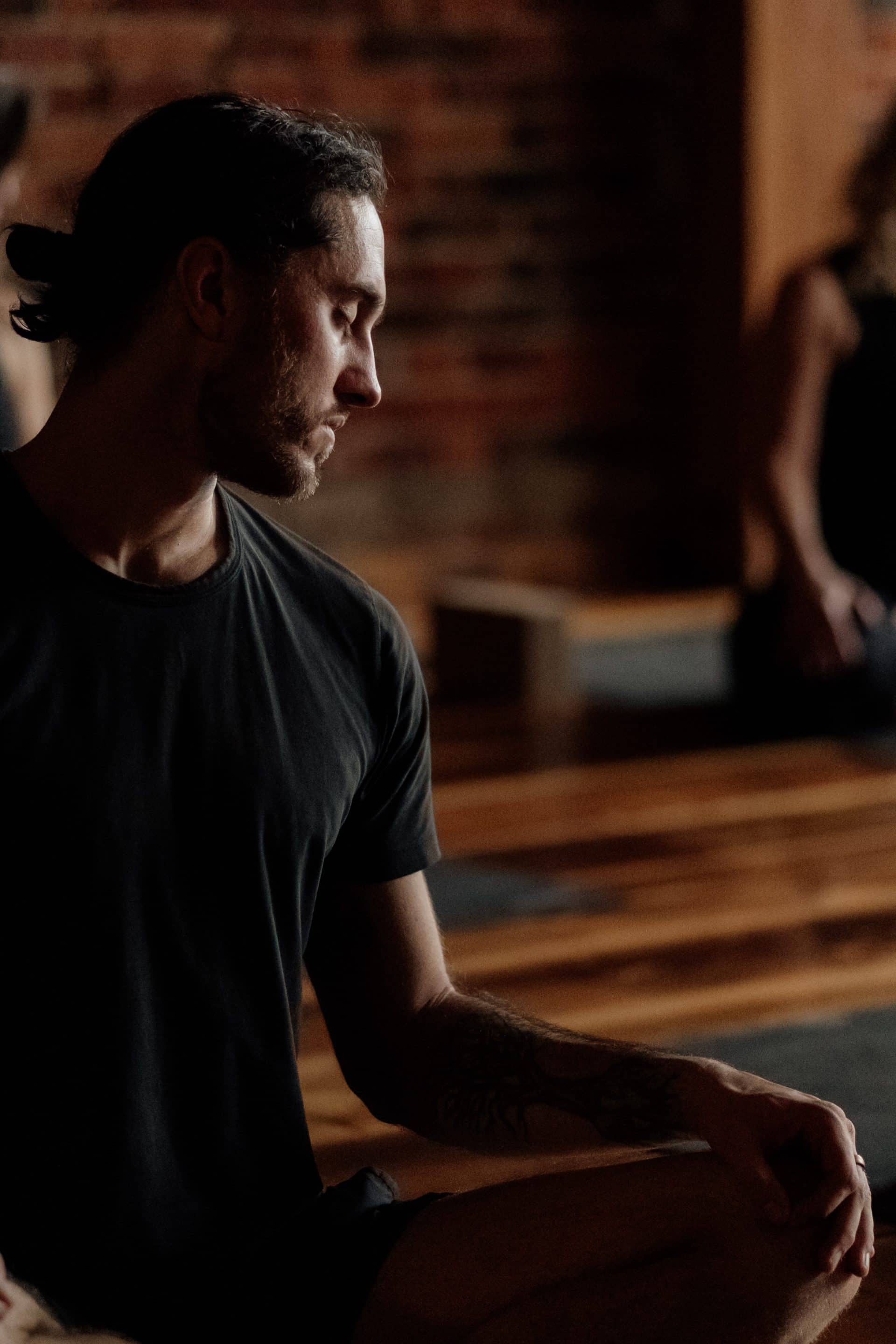 Man practicing seated yoga posture in serene environment