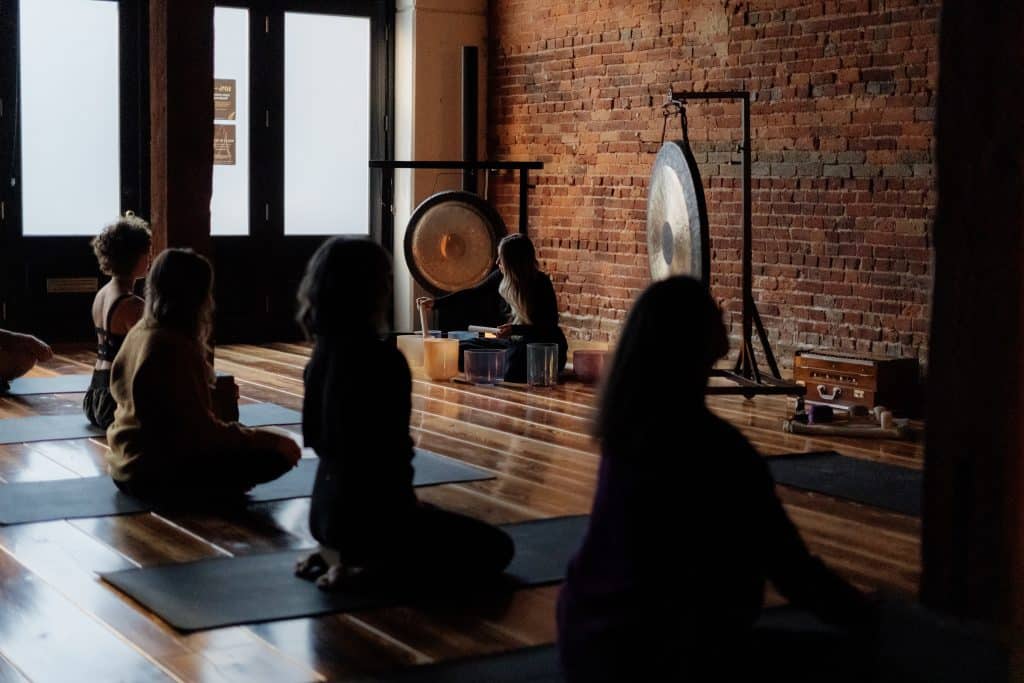 Group meditation in seated position during yoga class