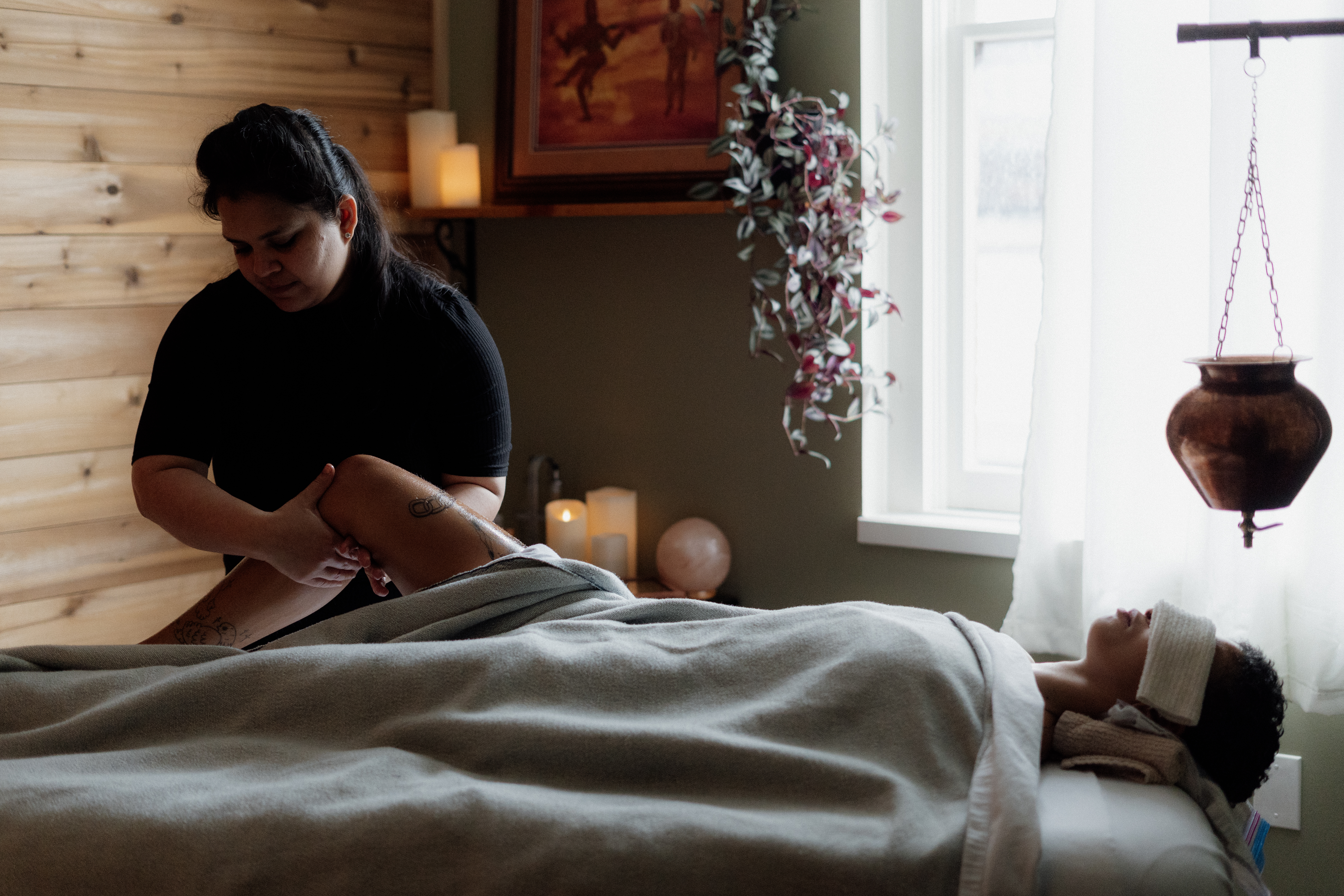 Woman therapist performing a soothing body massage for relaxation and better sleep.