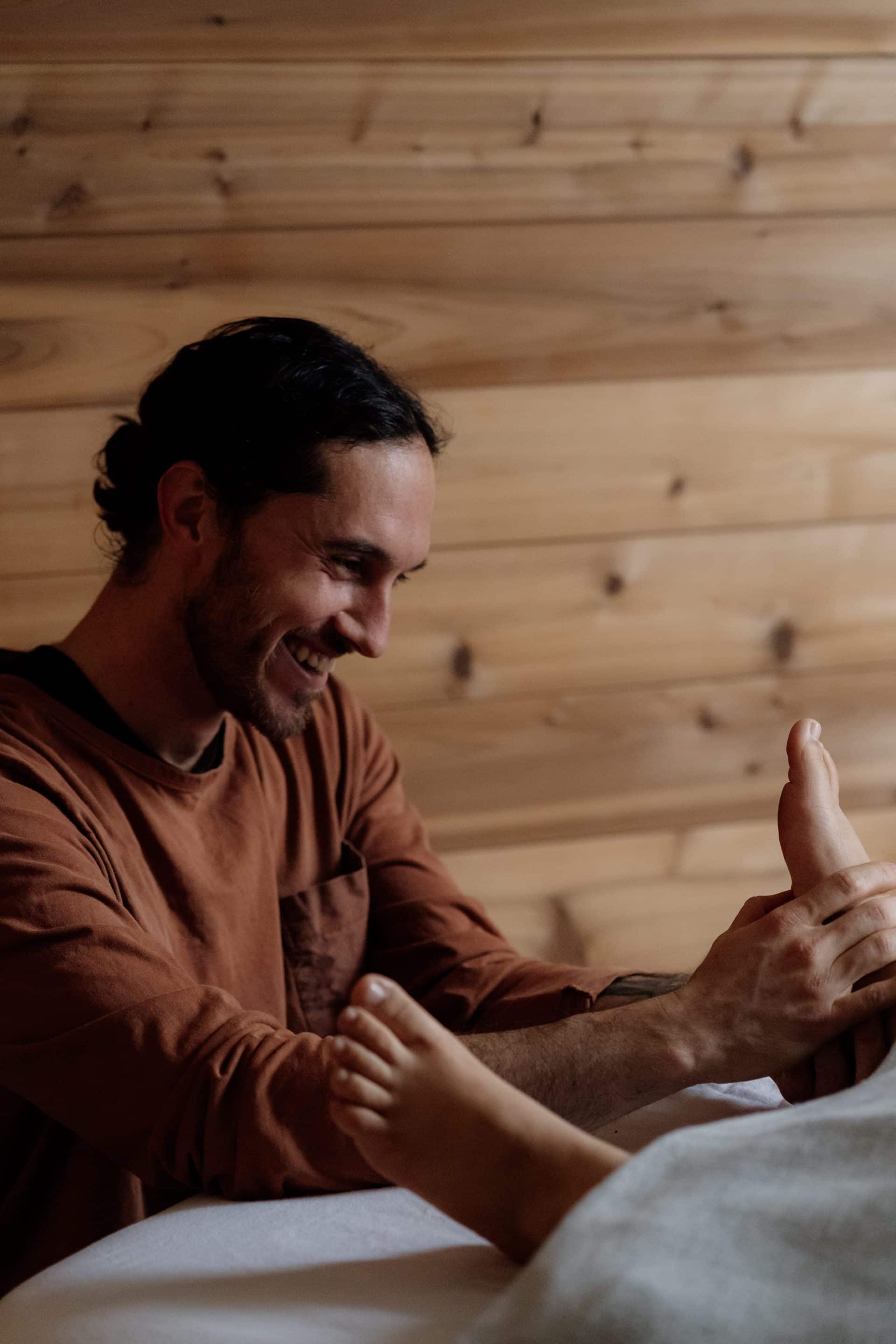 Male therapist conducting foot massage in Victoria wellness clinic