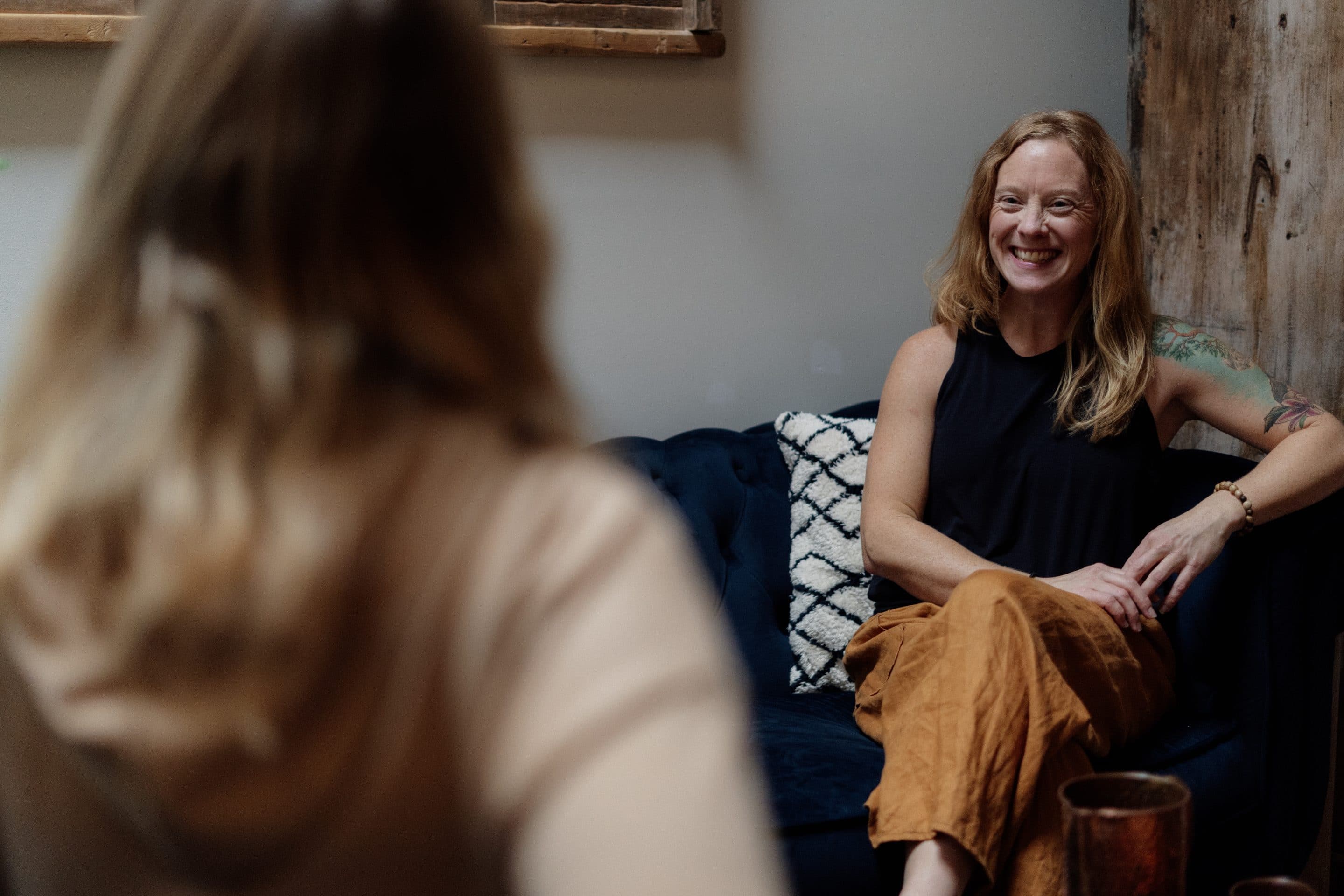 Woman receiving a holistic nutrition consultation in a calming wellness studio setting.