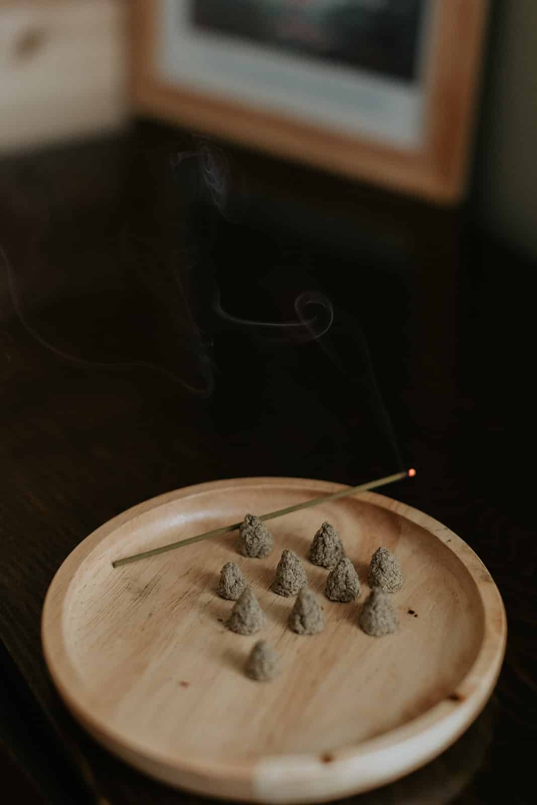 Moxibustion supplies and incense sticks neatly arranged on a wooden table, ready for a traditional therapy session.